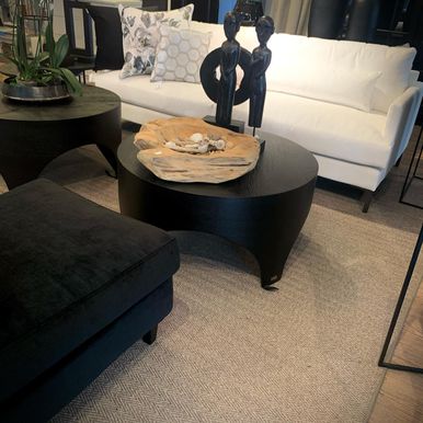 To svart bord, svart sofa, og hvit sofa